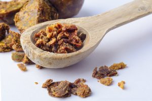 Propolis Granules In A Wooden Spoon. Bee Glue. Bee Products. Api